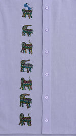 Load image into Gallery viewer, Close-up of the front panel of a hand-painted linen shirt featuring seven elephant motifs arranged vertically, with a blue bird perched on the uppermost elephant, showcasing detailed Bhil-inspired brushwork and painted surface details.