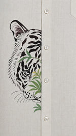 Load image into Gallery viewer, Close-up of tiger artwork crossing the front placket of the Padchinh hand-painted linen shirt on natural linen fabric.