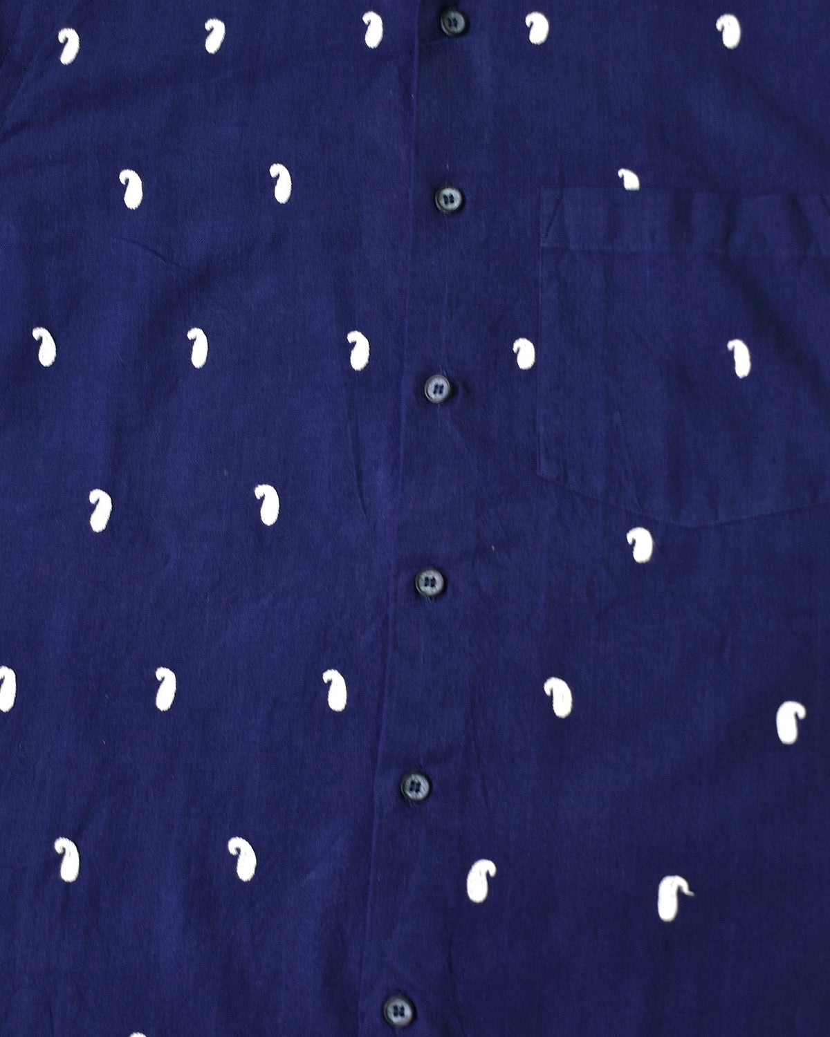 Kashmiri Aari embroidery with repeated buta motifs on a deep navy shirt, showcasing fine chain stitch detailing and evenly spaced traditional patterns