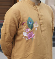 Close view of a linen kurta with hand-painted Pattachitra motif, showing fabric variation, light response, and surface behaviour.