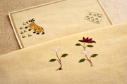 Comparison of Sujani and Chamba embroidery on textile, where Sujani’s narrative running stitch contrasts with Chamba’s structured floral needlework in Indian embroidery traditions.