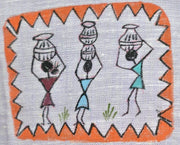 Hand-painted Warli figures on linen showing irregular line work, uneven zig-zag borders, and visible variation in traditional Indian textile surface.