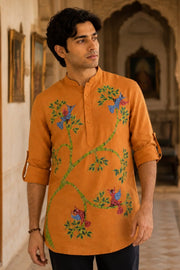 Young man wearing the Bhil Muse hand-painted pure linen short kurta in a historic palace setting, exploring how clothing can carry story, memory, and meaning beyond decorative design.