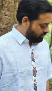 Close-up of a linen shirt with subtle embroidered motif, highlighting how fabric texture is noticed before the design.