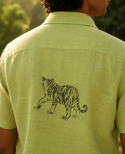 Young man wearing the Zero Edit Vanchar hand painted 100 percent linen half sleeve shirt highlighting the linen surface and tiger artwork in natural sunlight.