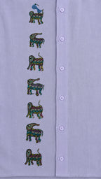 Close-up of the front panel of a hand-painted linen shirt featuring seven elephant motifs arranged vertically, with a blue bird perched on the uppermost elephant, showcasing detailed Bhil-inspired brushwork and painted surface details.