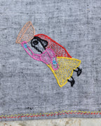 Close-up of the artwork showing a woman carrying a basket of food on a Bihar Sujani hand-embroidered khadi handkerchief.