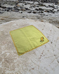 Hand-embroidered Bihar Sujani khadi handkerchief featuring a pet animal artwork, photographed on a weathered river stone.