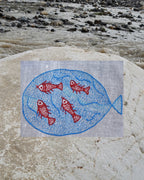 Close-up of a large blue fish artwork enclosing four red fish artworks on a Bihar Sujani hand-embroidered khadi handkerchief.