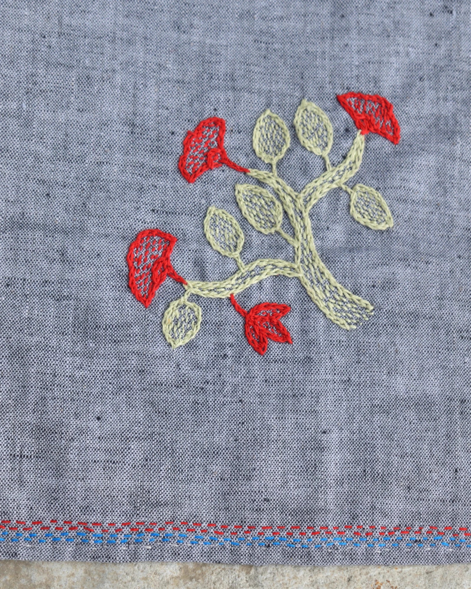 Close-up of the flowering branch artwork on a Bihar Sujani hand-embroidered khadi handkerchief.