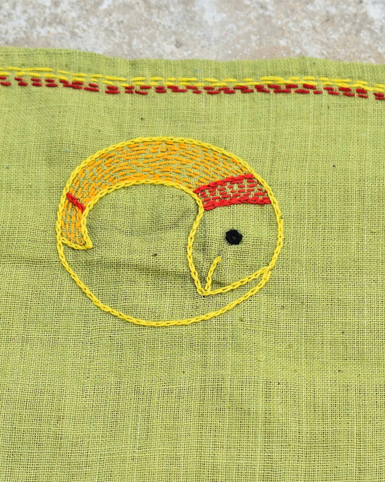 Close-up of the Yin Yang fish artwork on a Bihar Sujani hand-embroidered khadi handkerchief.