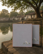 Chamba Rumal from the Jungle collection crafted in handwoven khadi cotton, featuring a hand embroidered duck and duckling walking together in the lower-left corner, hand hemmed and presented before a mirror that reveals identical embroidery on both sides through the traditional do-rukha technique.