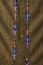 Gond hand-painted linen shirt featuring vertically extending botanical motifs constructed through layered linear dash detailing and rhythmic pigment strokes beside a structured button placket on an olive linen surface with visible weave texture, natural slub variation, and handcrafted artisanal character.