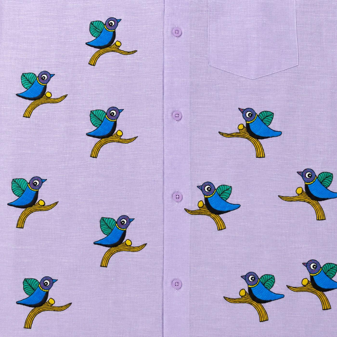 Close-up of Gond hand-painted linen shirt featuring scattered bird motifs perched on branching forms across the front panel, showing fine line work, balanced spacing, and hand-painted surface detail.