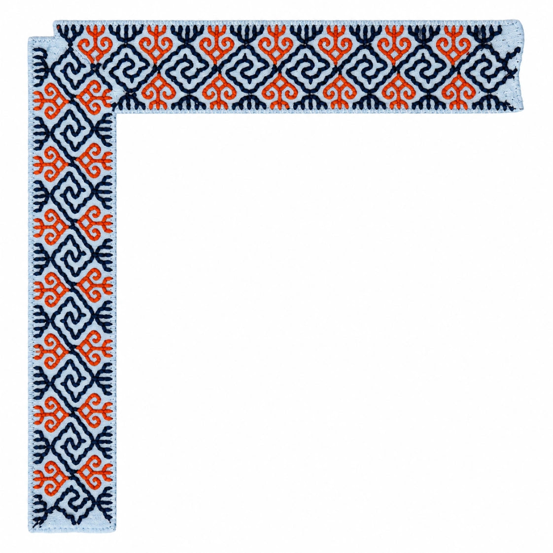 Close archival study of Kasuti hand embroidery featuring a Swastik motif rendered through the traditional Murgi and Gavanti stitch techniques of Karnataka. The border composition reveals directional symmetry, counted stitch progression, and layered geometric continuity, while ember and deep indigo threadwork emphasize the measured precision and structural clarity characteristic of historic Kasuti embroidery practice.