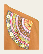 Odisha Pattachitra Madhava hand-painted linen short kurta left shoulder artwork close-up featuring a concentric ornamental border with floral, geometric, scalloped and intertwined serpentine bands.