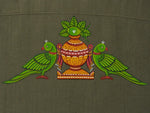 Load image into Gallery viewer, Close-up of hand-painted Odisha Pattachitra back motif on linen shirt, showing twin parrot forms, ceremonial kalash detailing, pigment variation, and textile weave.