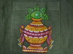 Close-up of hand-painted Odisha Pattachitra detailing on a linen shirt pocket showing a ceremonial kalash form with mango leaves, ornamental borders, and fine painted linework.