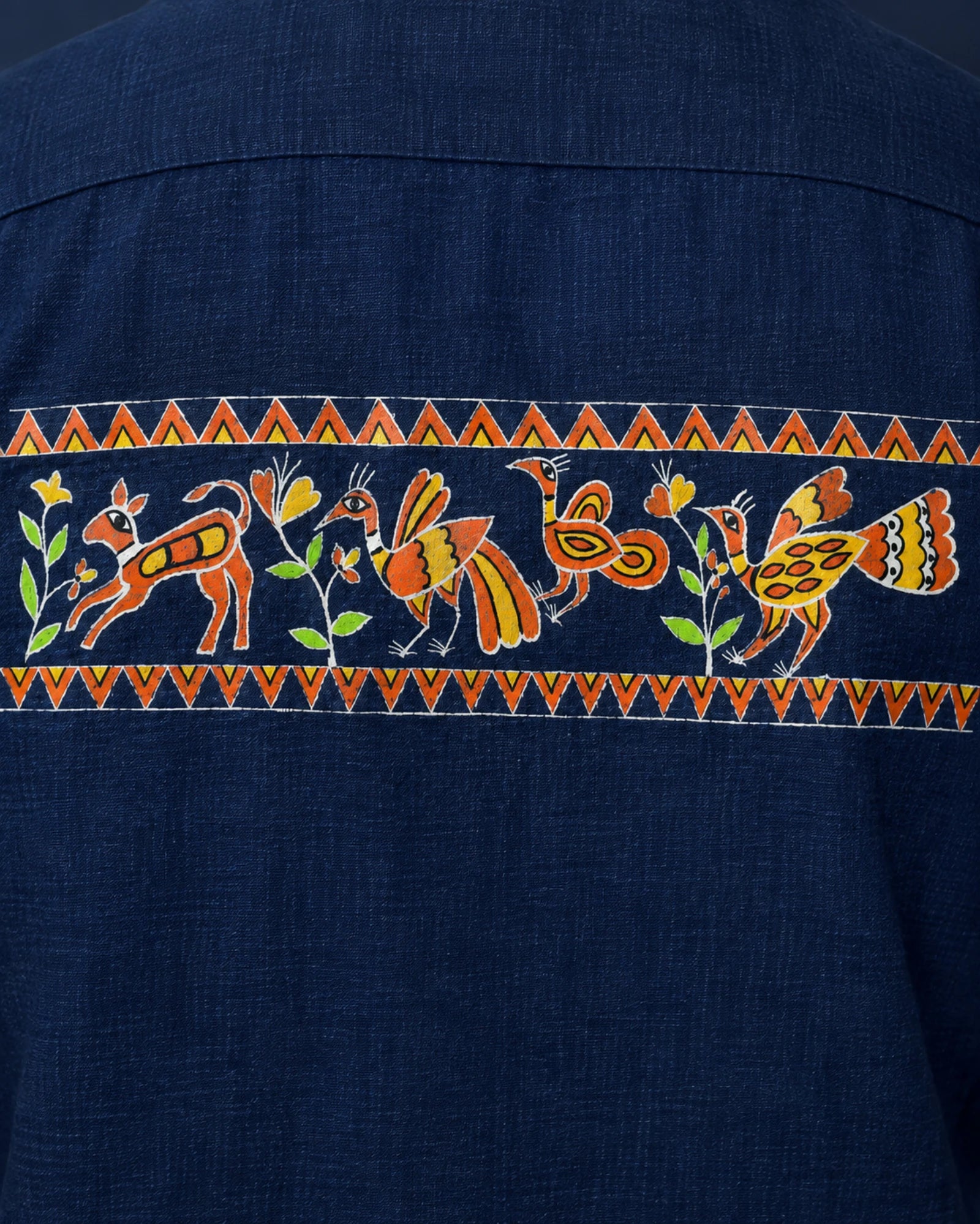 Close-up of the Sohrai Jeev Dhara upper back artwork featuring a peacock and peahen, fawn, flowering vegetation and hand-painted borders.