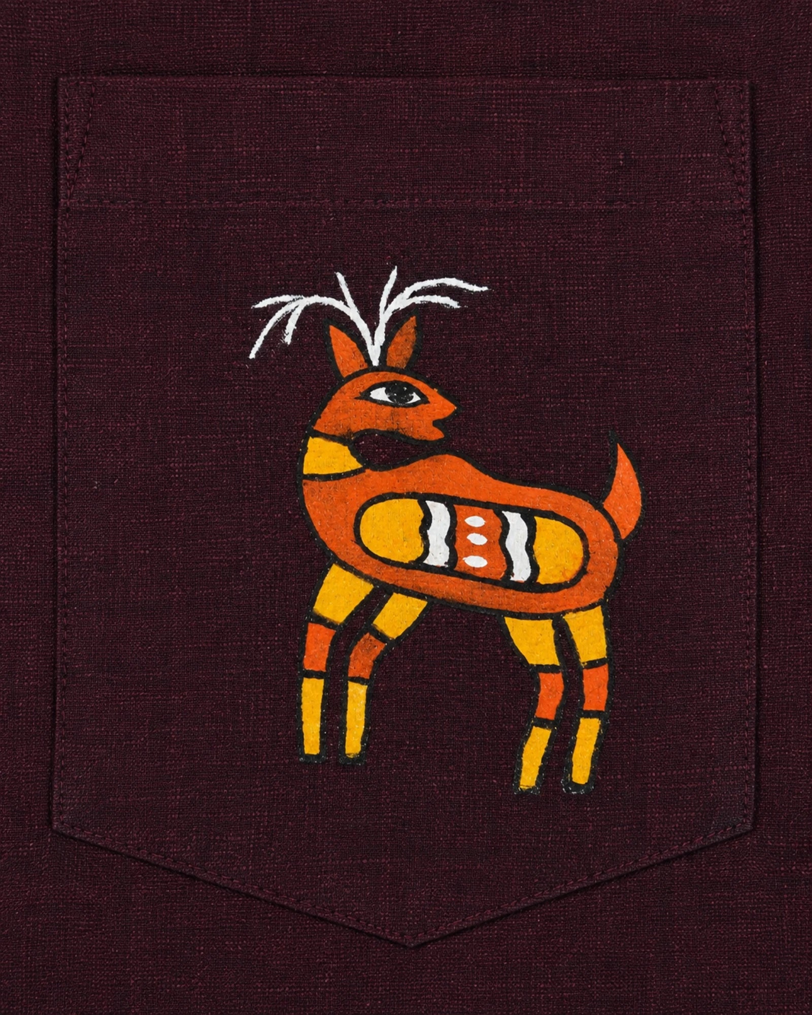 Sohrai Jeev Pravah hand-painted linen shirt pocket close-up featuring a solitary stylised deer rendered entirely by hand.