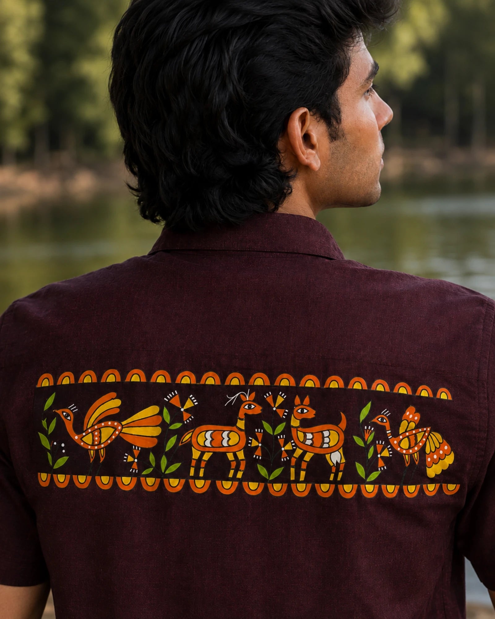 Sohrai Jeev Pravah upper-back artwork close-up featuring a peacock and peahen, stag and doe, flowering vegetation and hand-painted decorative borders.