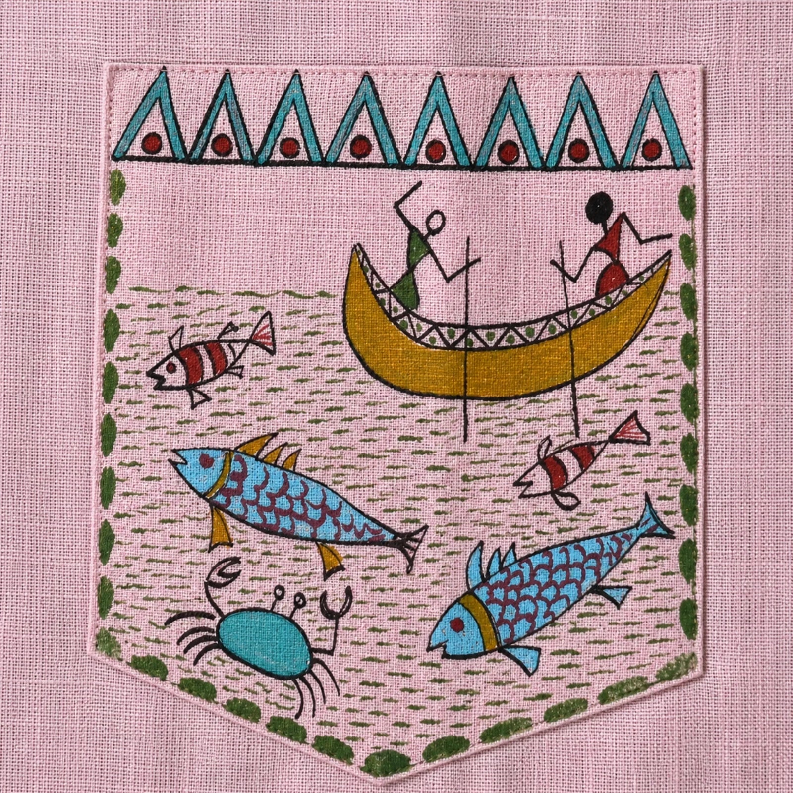 Closeup of the Matsya chest pocket artwork featuring two fishermen hunting fish and other sea creatures in a traditional river boat hand-painted on pure linen and framed by geometric Warli border.