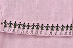 Warli hand-painted linen shirt sleeves border close-up featuring a continuous Warli tarpa dance painted along the sleeve hem.