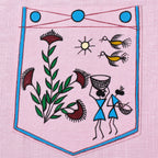 Close-up of the chest pocket artwork on the Warli Saanjh hand-painted linen shirt, featuring a flowering plant, a sun motif, two birds in flight, a basket carrier, and a figure carrying a shallow basket enclosed within a hand-painted traditional warli border.