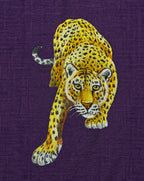 Back artwork close-up from the Aranyalok hand-painted linen shirt, featuring a solitary leopard advancing forward with one forepaw extended, showcasing the brushwork and spotted coat detailing of the original artwork.