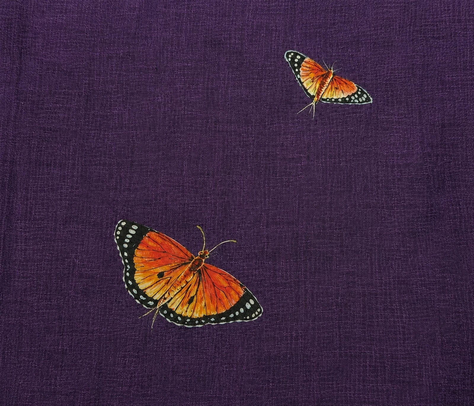 Top front detail from the Aranyalok hand-painted linen shirt featuring two individually hand-painted butterflies in flight, positioned across the upper front panel, showcasing layered brushwork, wing pattern detailing and the free-flowing nature-inspired composition of the artwork.