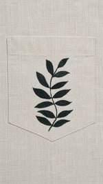 Load image into Gallery viewer, Botanical artwork detail above the pocket of the Padchinh hand-painted linen shirt, revealing the brushwork and fine line detailing of the original artwork.